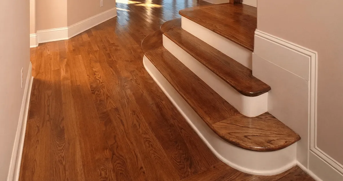 Base floor of a staircase with professionally restored wood flooring in Dayton OH
