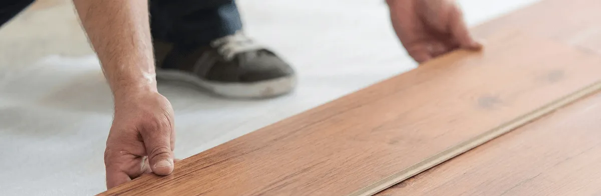 A professional installing laminate flooring in Dayton, OH